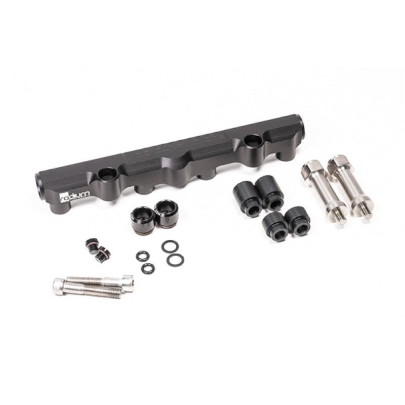 Black anodized Radium Engineering secondary top feed conversion fuel rail for Mazda 13B-REW rotary engines.