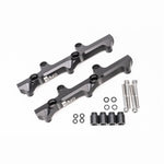 A pair of black anodized Radium Engineering high-flow fuel rails for the Nissan R35 GT-R VR38DETT engine.