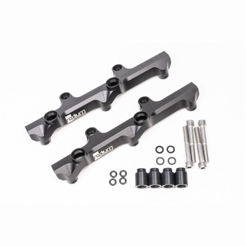 A pair of black anodized Radium Engineering high-flow fuel rails for the Nissan R35 GT-R VR38DETT engine.