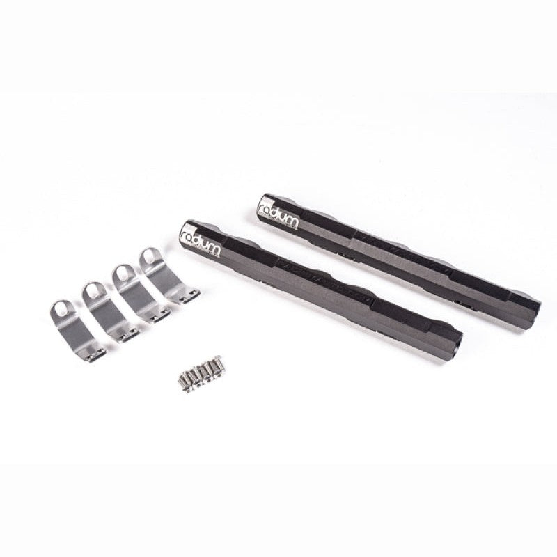 Black anodized Radium Engineering fuel rails for Nissan VQ engines showing 8AN ORB ports and laser engraving.