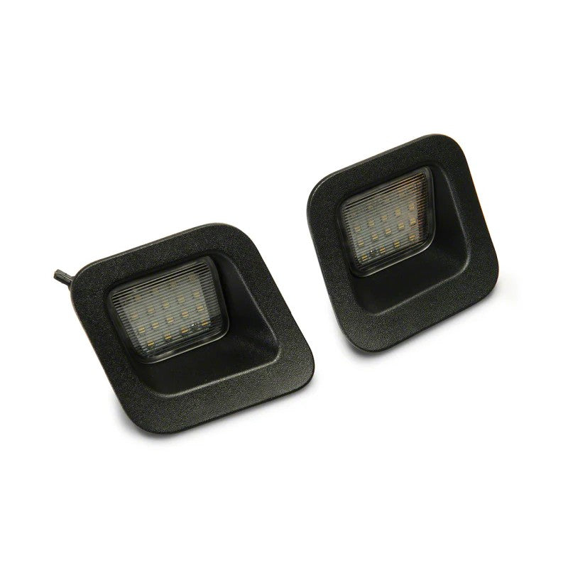 Pair of Raxiom Axial Series LED license plate lamps with 18 LEDs and black housings for 2003-2018 Dodge/Ram 1500.