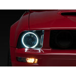 Raxiom Axial Series black projector headlights with CCFL halo rings and smoked lenses for 2005-2009 Mustang.