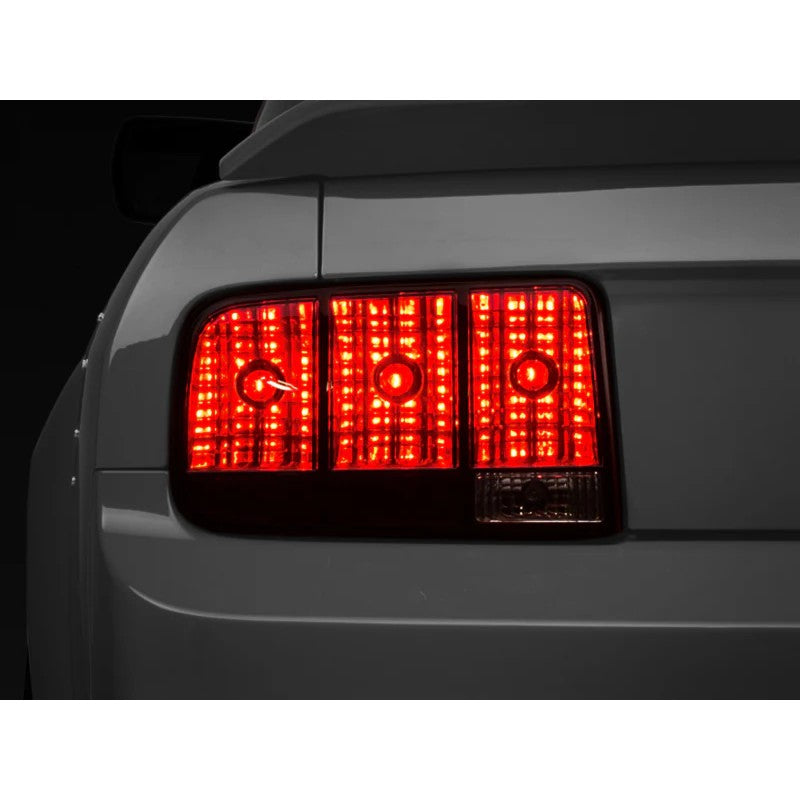Set of two Raxiom smoked tail lights with black housings for 2005-2009 Ford Mustang models.