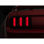 Raxiom Vector V2 LED tail lights with black housings and smoked lenses for 2005-2009 Ford Mustang.