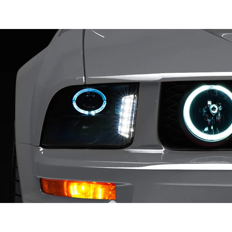 Pair of Raxiom black housing projector headlights with smoked lenses and LED halos for 2005-2009 Ford Mustangs.