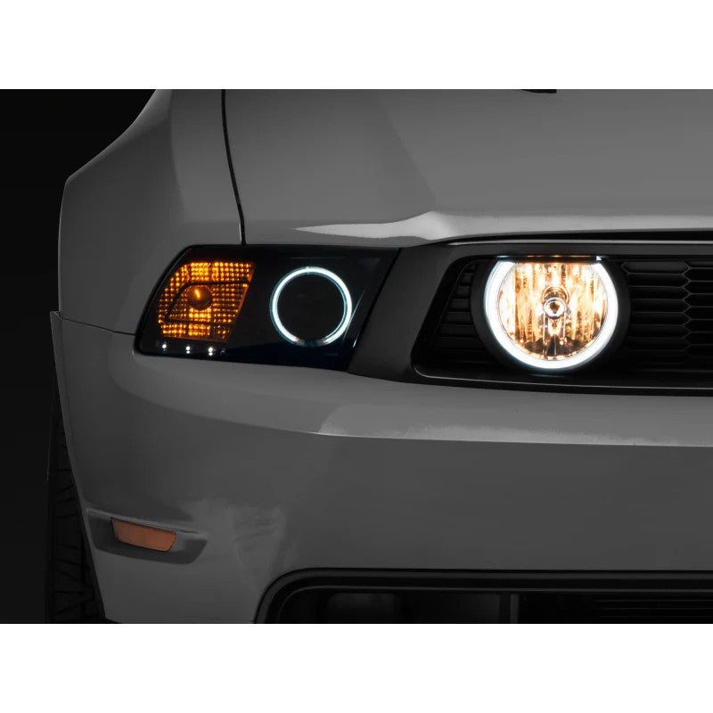 Chrome Raxiom fog lights with integrated white LED halo rings and clear lenses for 2005-2012 Ford Mustang GT.