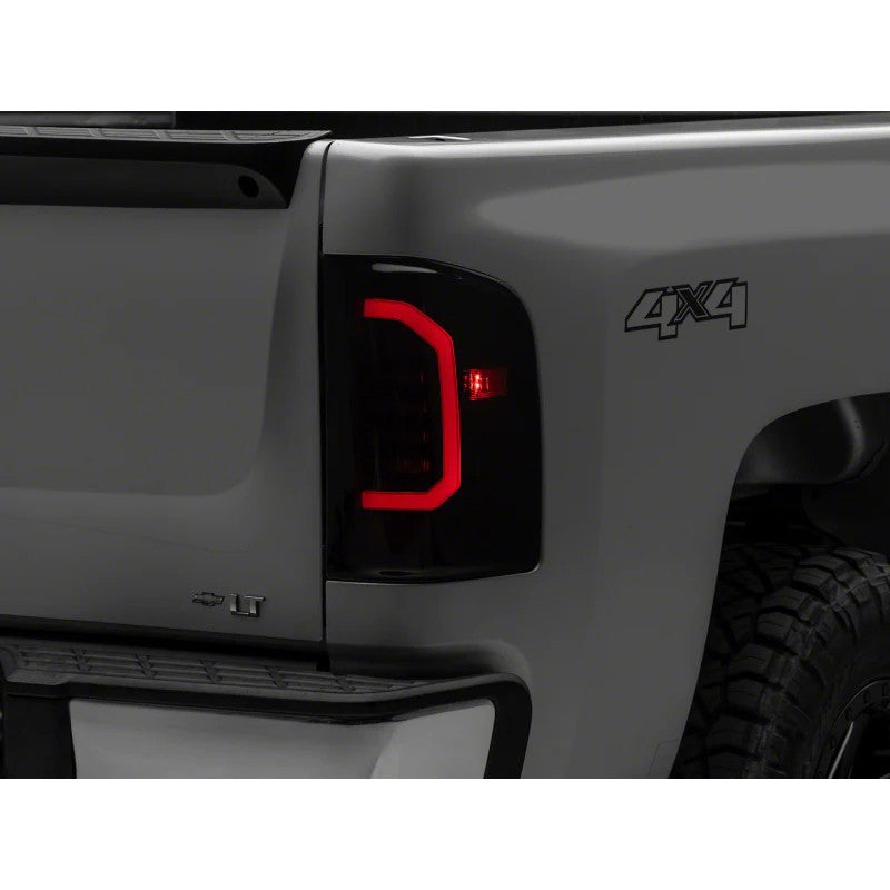 Raxiom Axial Series LED tail lights with smoked polycarbonate lenses and black ABS housings for 2007-2014 Silverado.