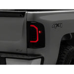 Raxiom Axial Series LED tail lights with smoked polycarbonate lenses and black ABS housings for 2007-2014 Silverado.