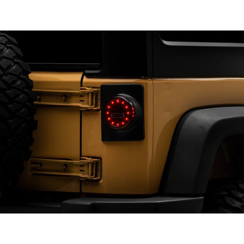 Pair of Raxiom Axial Series Halo LED Tail Lights with black housings and clear lenses for 2007-2018 Jeep Wrangler JK