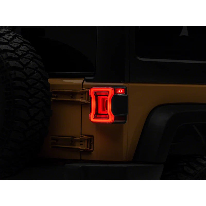 Raxiom Axial Series JL Style LED tail lights with black housing and red lenses for 2007-2018 Jeep Wrangler JK.