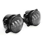 Raxiom Axial Series 4-inch round LED fog lights with black die-cast aluminum housings and clear polycarbonate lenses.