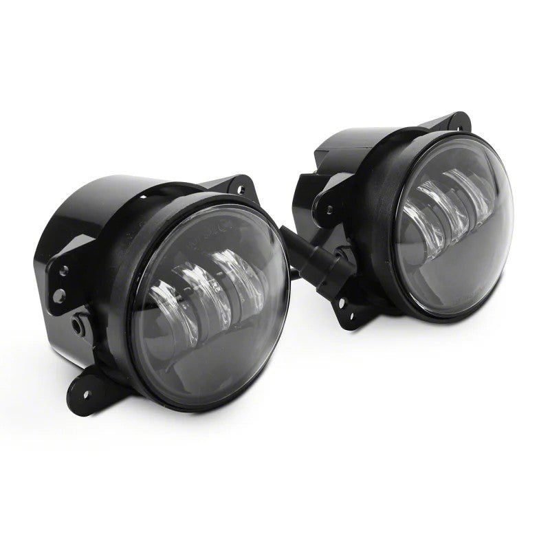 Raxiom Axial Series 4-inch round LED fog lights with black die-cast aluminum housings and clear polycarbonate lenses.