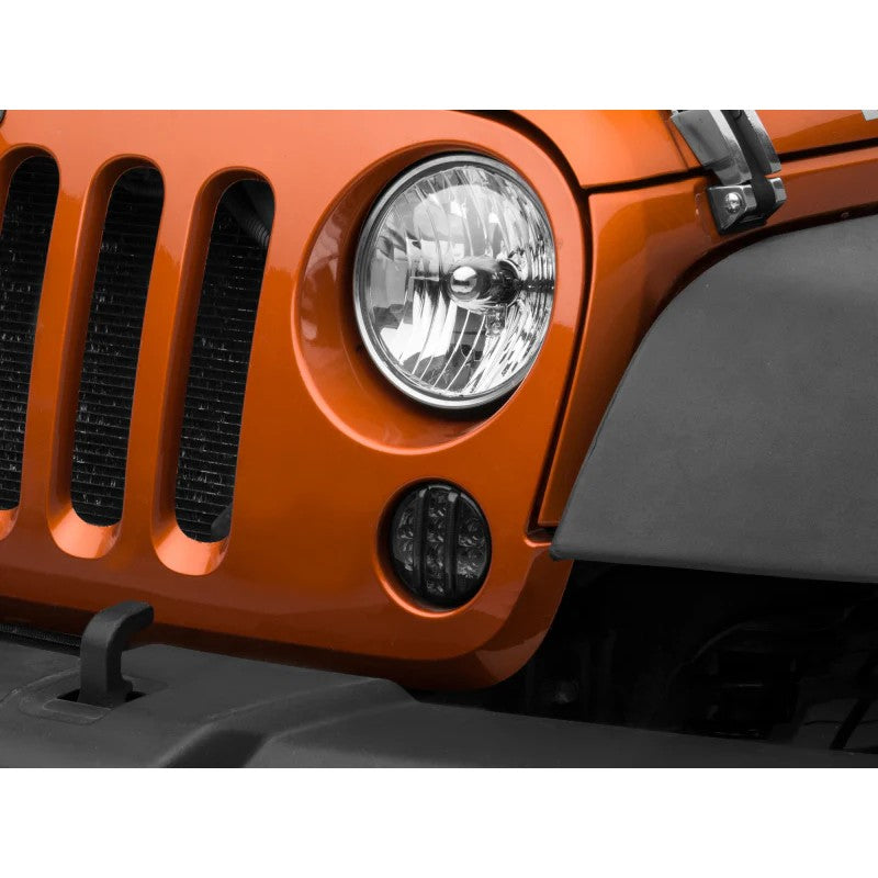Raxiom Axial Series smoked LED front turn signal housings with amber LEDs and DRL accents for 2007-2018 Jeep Wrangler JK.