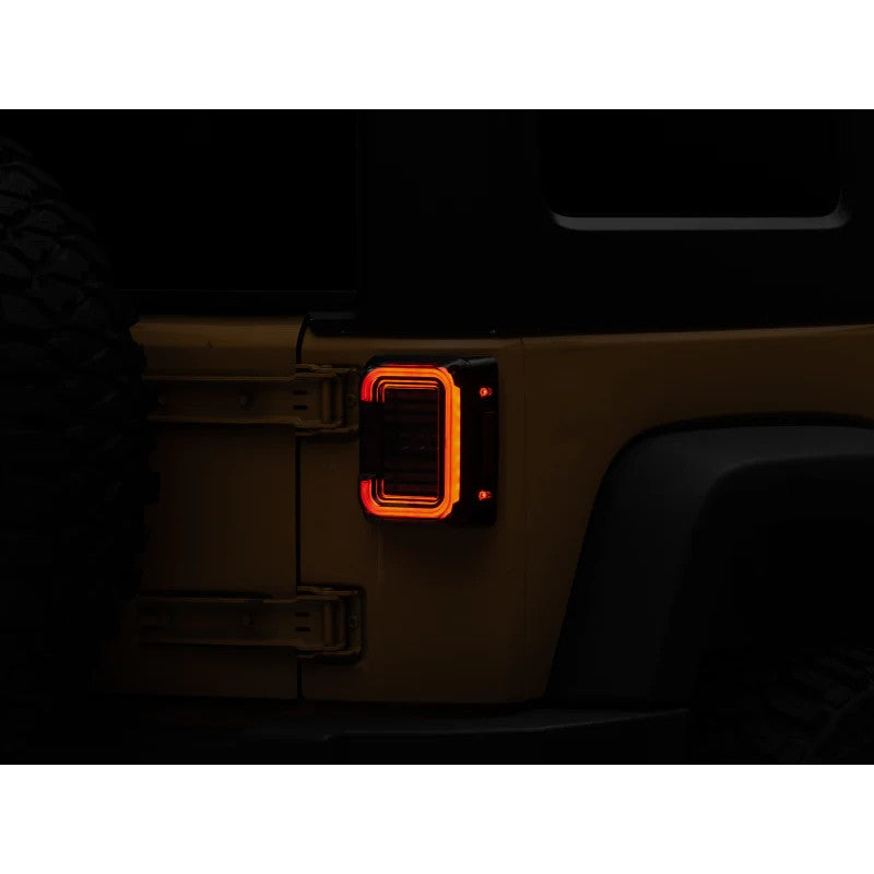 Raxiom Axial Series LED halo tail lights with black housings and dark smoked lenses for 2007-2018 Jeep Wrangler JK