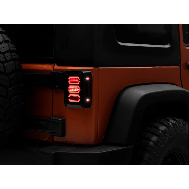 Raxiom LED tail lights for Jeep Wrangler JK with black housings and smoked lenses.