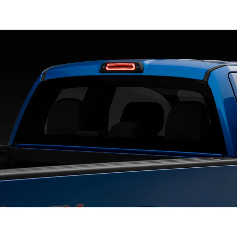 Raxiom Axial Series smoked lens LED third brake light for 2009-2014 Ford F-150 showing red brake and white cargo LEDs.