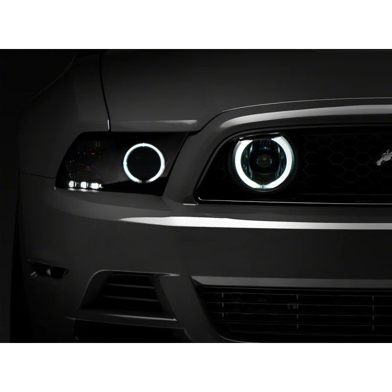 Pair of Raxiom fog lights for 2013-2014 Mustang GT featuring chrome housings, clear lenses, and CCFL halo rings.