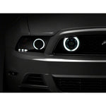 Pair of Raxiom fog lights for 2013-2014 Mustang GT featuring chrome housings, clear lenses, and CCFL halo rings.