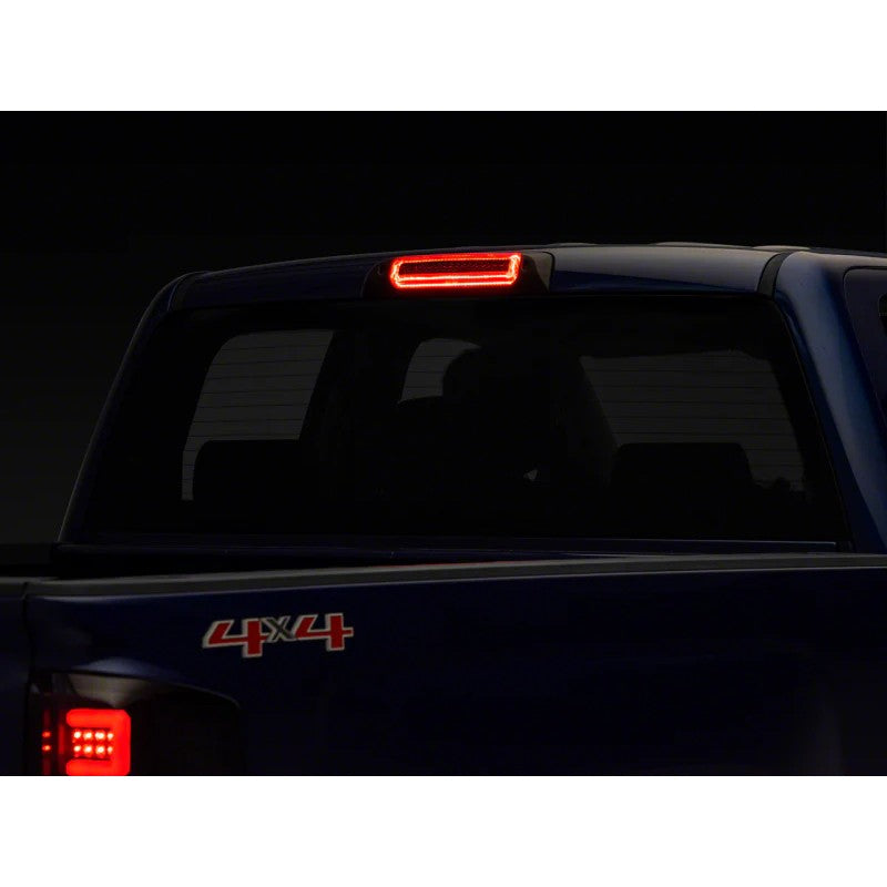 Raxiom Axial Series smoked LED third brake light with integrated cargo light for 2014-2019 Silverado and Sierra trucks.
