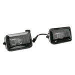 Pair of Raxiom Axial Series LED fog lights with textured black aluminum housings and clear polycarbonate lenses.