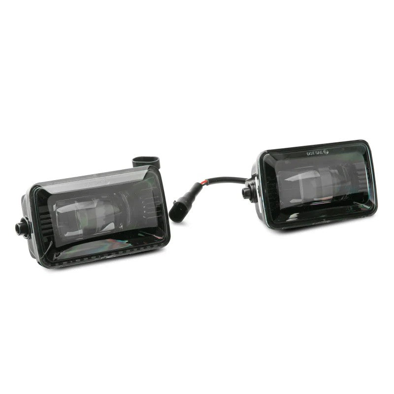 Pair of Raxiom Axial Series LED fog lights with textured black aluminum housings and clear polycarbonate lenses.
