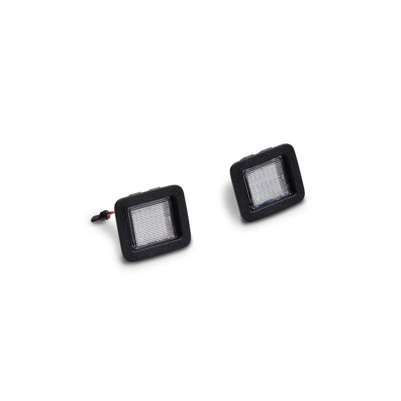 Raxiom Axial Series LED license plate lamp assembly with black housing and clear lens for 2015-2023 Ford F-150.