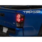 Raxiom XW Series Sequential LED Tail Lights with black housing and clear lens for 2016-2023 Toyota Tacoma