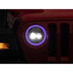 Raxiom Axial 9-inch black housing LED headlights with illuminated RGB halos and clear polycarbonate lenses for Jeep JL and JT.