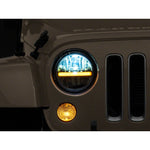 Raxiom Axial 7-inch round LED headlights with black housing, clear lens, and integrated DRL bar for Jeep Wrangler.