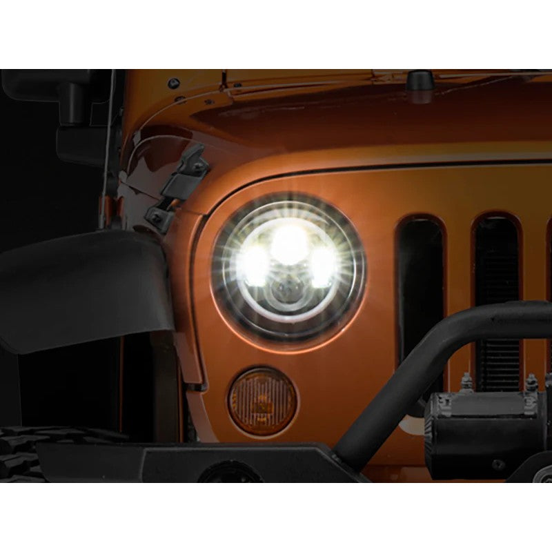 Raxiom Axial 7-inch LED halo headlights with black housings and clear lenses showing white DRL and amber signal functionality