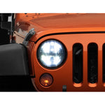 Round 7-inch Raxiom Axial Series LED headlights with black internal housings and clear lenses for Jeep Wrangler.