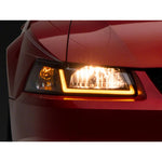 Raxiom Axial Series headlights with black housings, clear lenses, and integrated LED DRL bar for 1999-2004 Ford Mustang