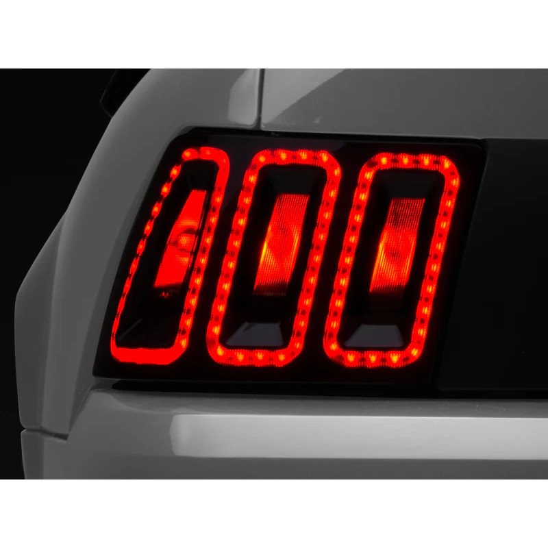 Pair of Raxiom Icon LED Tail Lights featuring black housings and smoked lenses for 1999-2004 Ford Mustang