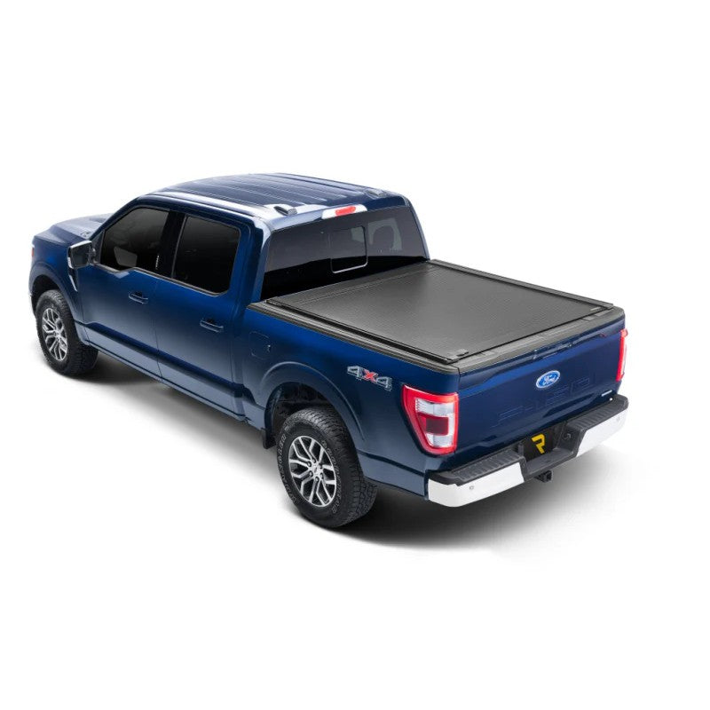 Matte black RetraxONE XR retractable tonneau cover with integrated T-slot rails installed on a Ford Super Duty short bed