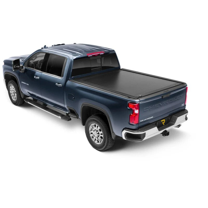 RetraxONE MX matte black retractable tonneau cover installed on a GMC Sierra 2500 HD with a 6 foot 9 inch bed.