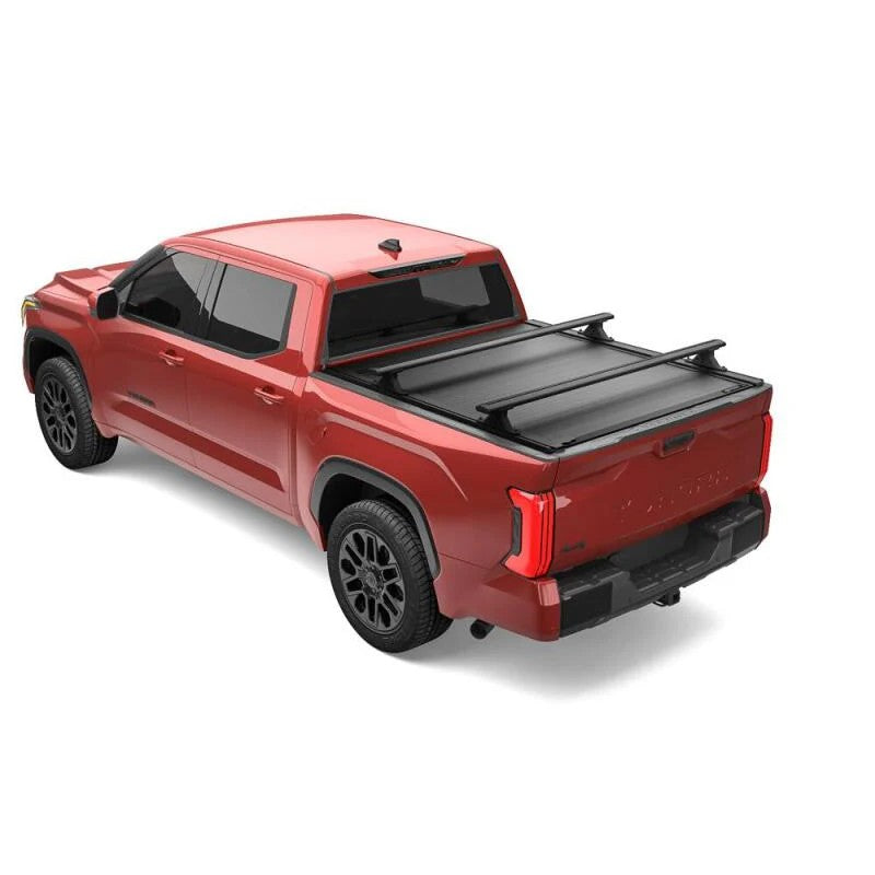 RetraxONE XR retractable bed cover on a Toyota Tundra showing integrated T-slot accessory rails and matte black finish