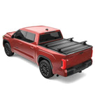 RetraxONE XR retractable bed cover on a Toyota Tundra showing integrated T-slot accessory rails and matte black finish