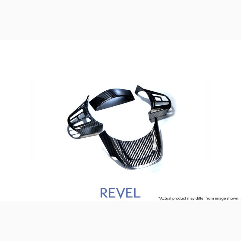 4-piece set of Revel GT dry carbon fiber steering wheel cover inserts for 2020 Toyota GR Supra.