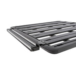 Black powder-coated steel LED light mounting bracket for Rhino-Rack Pioneer roof systems.