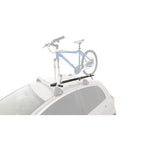 Rhino-Rack Road Warrior fork-mount roof bike carrier for C-channel crossbars showing locking skewer and wheel strap.