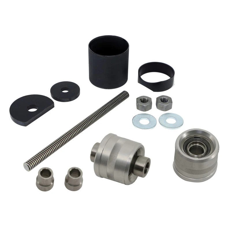 A pair of Ridetech Rear Upper R-Joints with the included metal removal and installation tool.