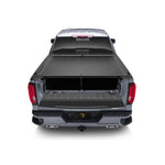 Roll-N-Lock M-Series retractable tonneau cover showing black vinyl-over-aluminum slats and compact storage housing.