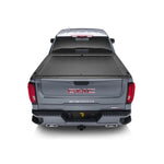 Roll-N-Lock M-Series retractable tonneau cover with black vinyl-over-aluminum slats and compact storage housing.