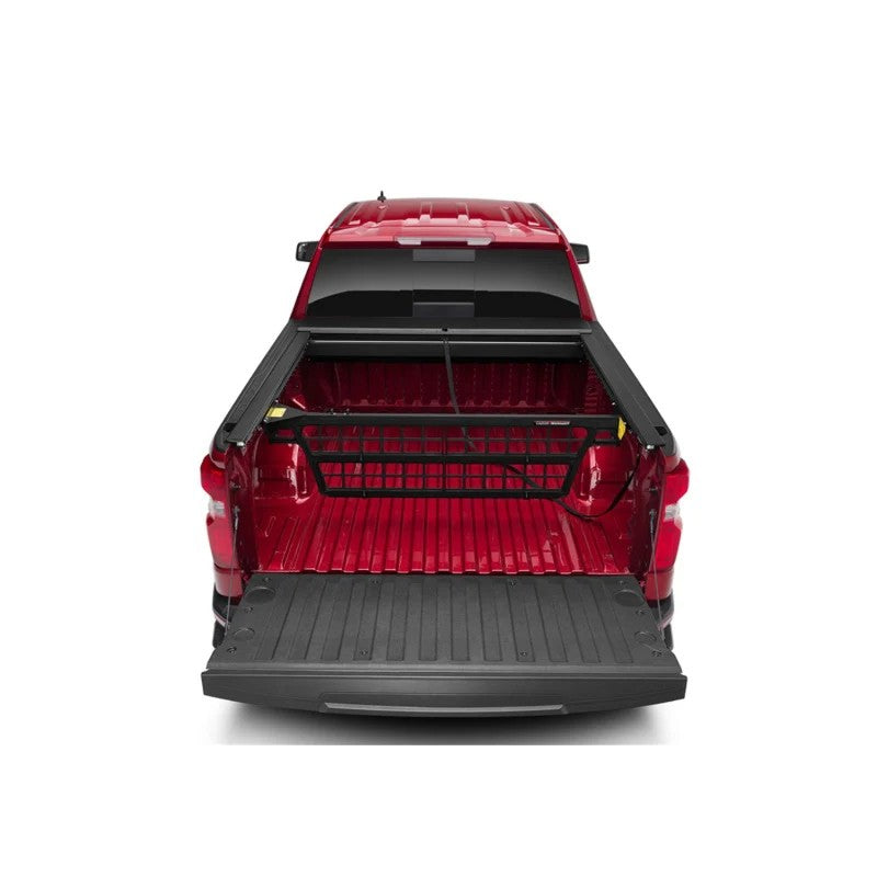 Roll-N-Lock Cargo Manager movable bed divider with driver-side control levers and lateral tie-offs.