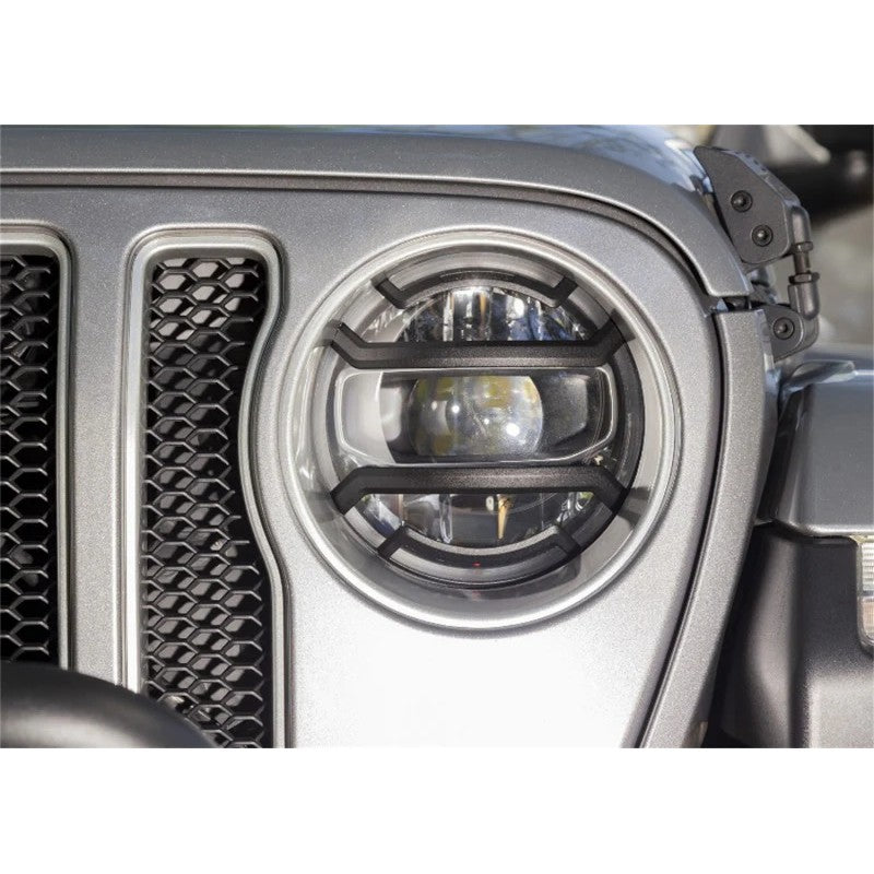 Pair of black cast aluminum Rugged Ridge Elite headlight guards with geometric mesh design.