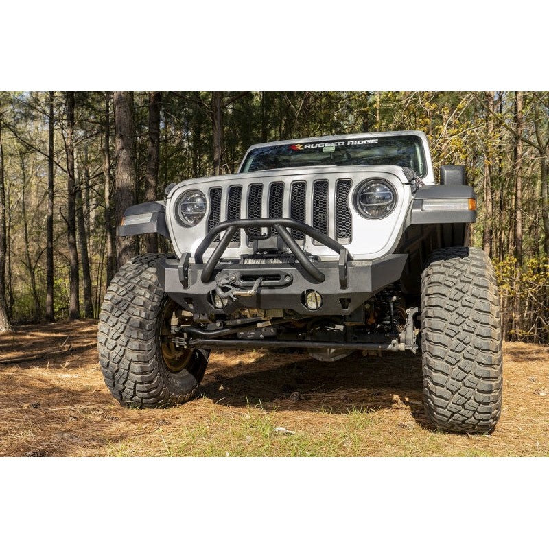 Satin black Rugged Ridge HD Series stubby front bumper with recessed winch plate and dual-drilled recovery hooks.