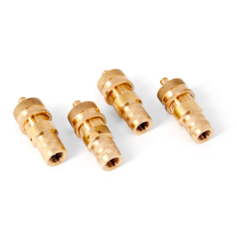 Four machined brass adjustable tire deflators from Rugged Ridge for off-road use.