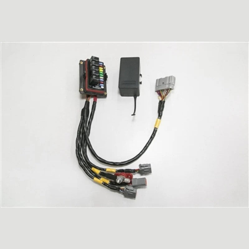 Rywire V3 race-style chassis adapter featuring a compact integrated relay bank and fuse block for custom wiring.