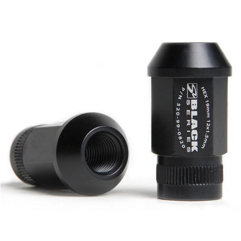 Set of 20 Skunk2 Black Series 12x1.5 forged 7075 aluminum lug nuts with knurled ends and black anodized finish.