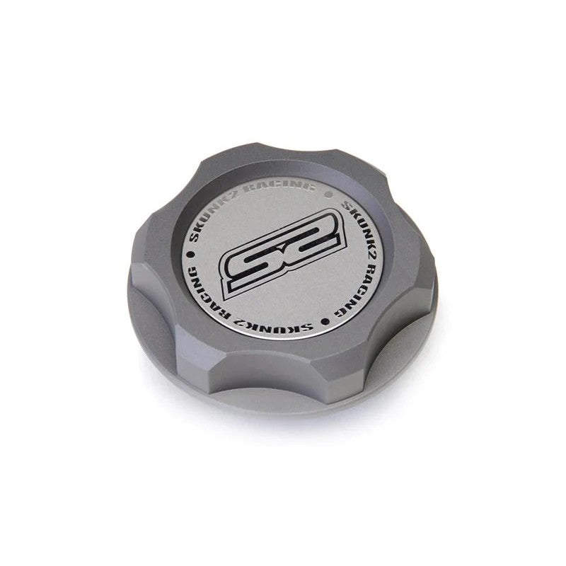 Gun metal hard anodized Skunk2 billet oil cap with acid-etched logo and M33 x 2.8 thread pitch.
